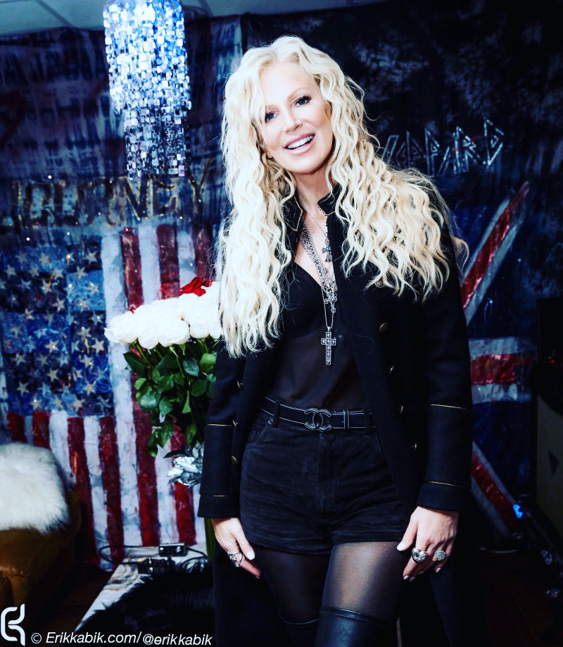 Michaele Schon next to American Flag on Tour with Neal Schon and Journey