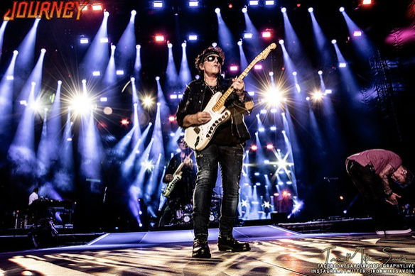 Neal Schon Plays Guitar in vivid stage lights